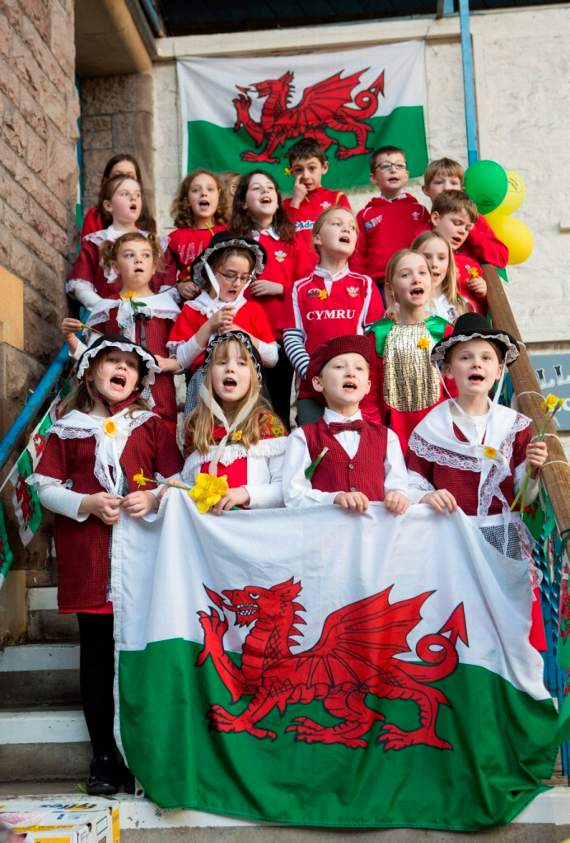 Ysgol y Fenni choristers performing on the market hall steps
