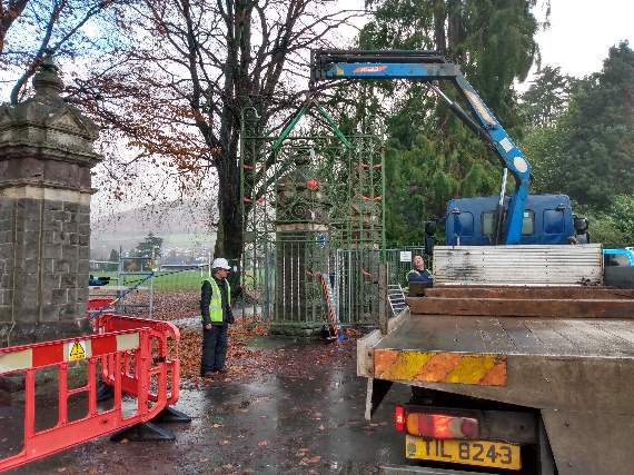 Workmen remove the gates from Bailey Park so they can be repaired off site
