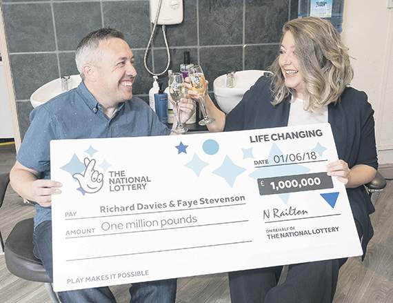 Richard Davies and Faye Stevenson with the cheque for £1million