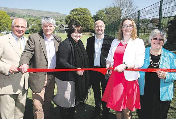 Kirsty Williams cuts the ribbon to open the new artificial pitches at Crickhowell High School
