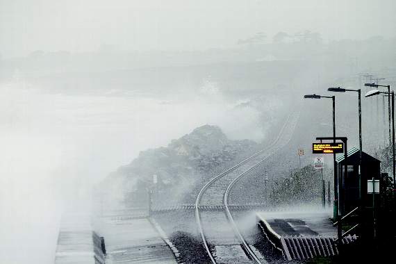High winds and torrential rain batter the railway line and seafront near Llanbedr
