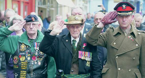 Mr Griffiths, Mr Hughes and Lt Col Norrington-Davies during the two-minute silence