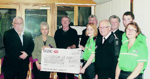 Members of St John Ambulance Ceredigion receive their cheque for £1,426.09 from Glanville Rees, of Team Rasus, at the Feathers Hotel, Aberaeron