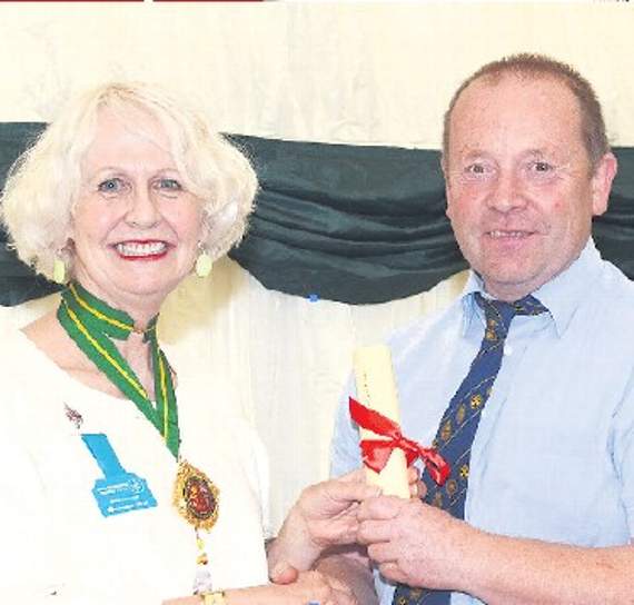 Tegwyn P Jones receiving his certificate of Fellowship from Rosie Carne, national chairperson of CARAS