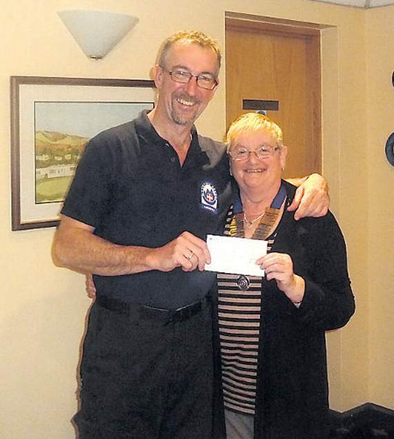 Tywyn Inner Wheel presidnet chris Lewis presenting a donation to Phil Parton of the Aberdyfi Search and Rescue Team