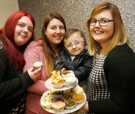 Three sisters, Tina Rees, Lisa Barnikel (with five-year old son Daniel) and Claire Lloyd, owner of the hair salon, selling cakes