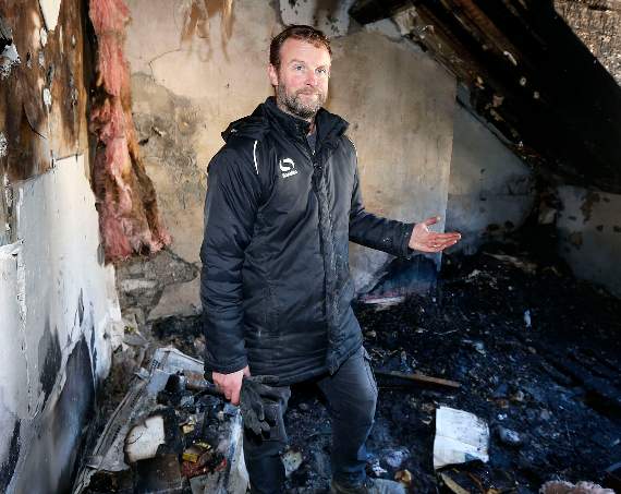 Owner of the property, Matthew Sims, surveying the damage inside the house after the blaze