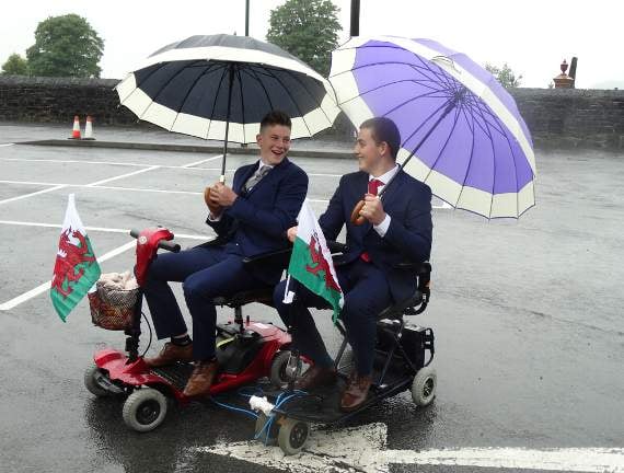 Rhys and Llyr arrived by mobility scooter while clutching their very smart umbrellas!
