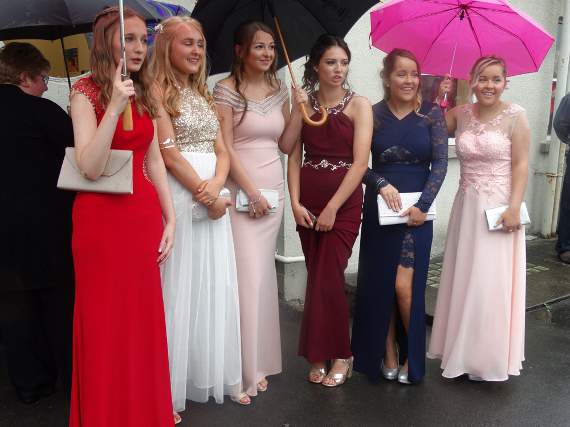 Ffion, Ellie, Rhian, Lyndsay, Medwen and Menna had to shelter under umbrellas as they arrived at the school