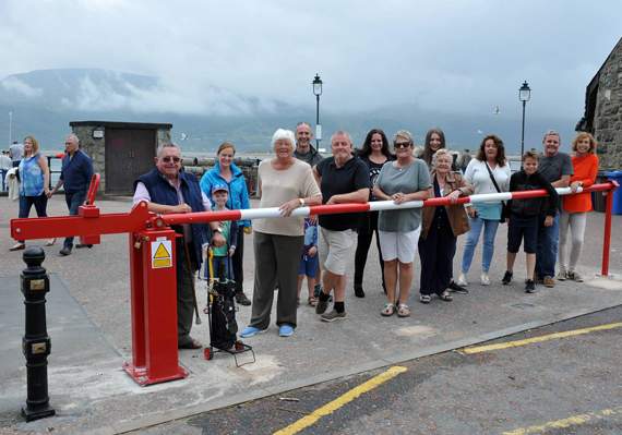 Danny Brooks (seen centre wearing a black T-shirt), with a group of Barmouth residents who are upset about the new barrier