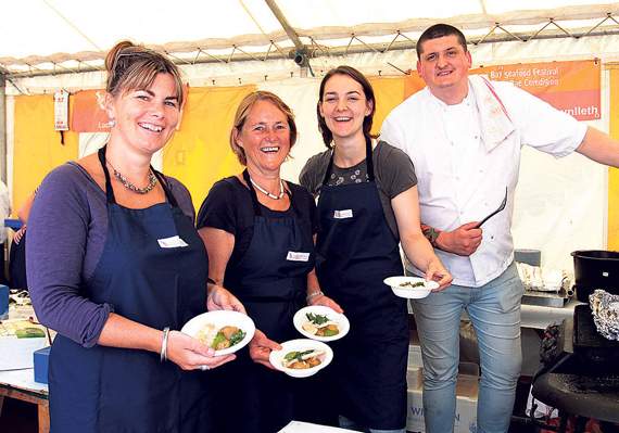 Lowri Goss, Cherry Davidson and Amelia Eriksson tempting the visitors with a dish of white fish in wild garlic sauce with wild herbs from the coast prepared by Gareth Hall of Ynyshir Hall