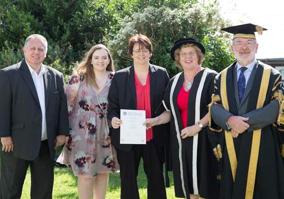 From left: Emily Price’s father John, sister Katie and mother Natasha with vice-chancellor Prof Elizabeth Treasure and pro chancellor Glyn Rowlands