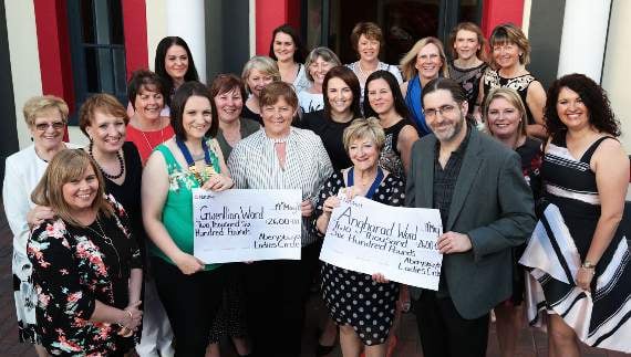 Carys Davies, midwife at Gwenllian Ward, and Paul Harries of Angharad Ward receive cheques for £2,600 from members of Aberystwyth Ladies Circle