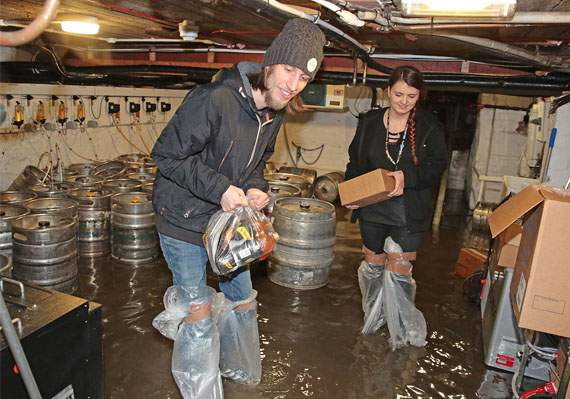Trying to clear up in the cellar of Lord Beechings are chef Connor Weaving and team leader Tara Heywood