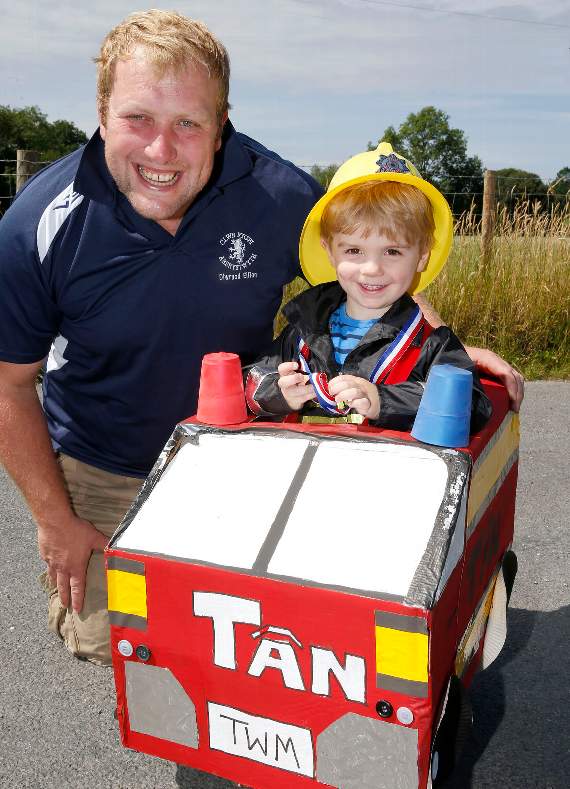 Two-year-old Tomos Eben Lewis gained first prize in the four years and under class, dressed as Sam Tân. He is pictured with dad Prys