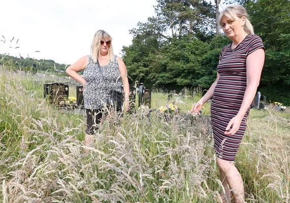 Pictured at Plascrug Cemetery, struggling with the knee-high grass are Mandy Connors (right) and sister Julie
