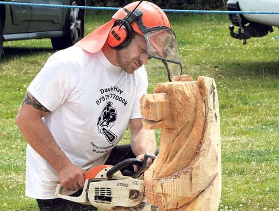 Sculptor Dave Hay taking part in the speed carving competition where each competitor was given half an hour to carve an animal which would later be auctioned on site. This proved to be very popular with the crowds at the fair