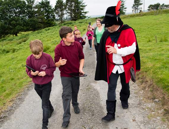 The children with local guide Dafydd Wyn Morgan playing the role of the 16th century highwayman Twm Siôn Cati