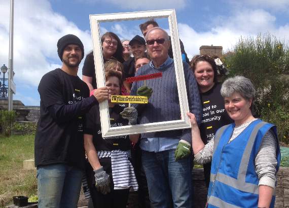 Staff from Mind and Aberystwyth M&S store work to transform a mindfulness garden