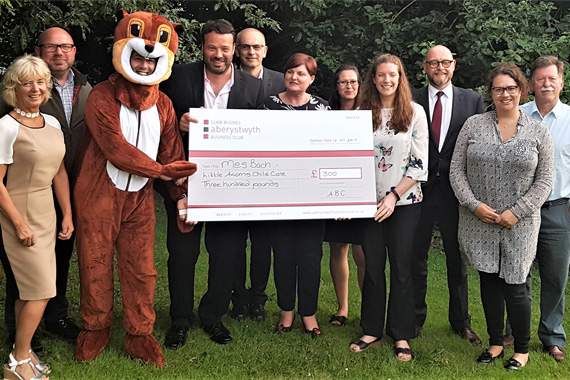 Mês Bach Childcare presentation, from left: Mearina James, James Drew, Mark Longman, Eddy Webb, John Glasby, Julie Grabham, Hayleigh Routledge, Angharad Reenie Davies, Nigel Kennedy, Rhiannon Rees and Tony Bates