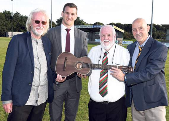 Left to right: Paul Brett, a local businessman who designs vintage guitars – this one was auctioned off on the evening – Sam Warbuton; Wil Martin, Pwllheli rugby club chairman and head coach Ian Jones