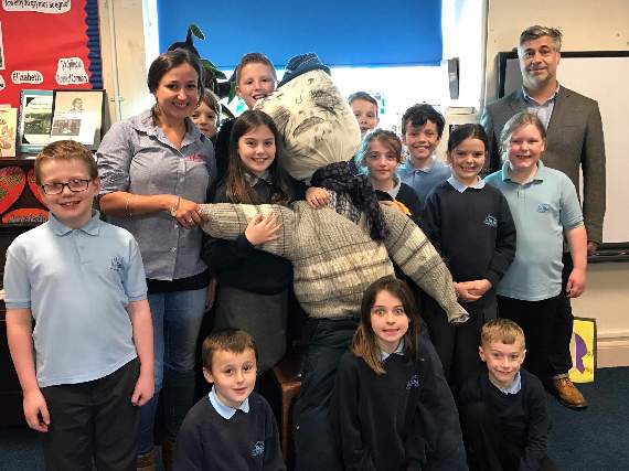 The children presenting their guy to David Evans and Gemma Webb from Dylan’s Restaurant