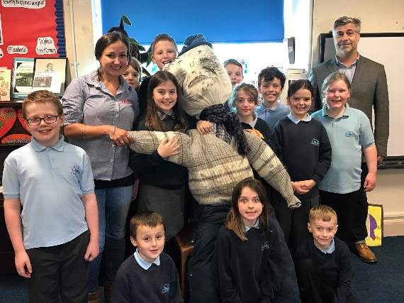 The children presenting their guy to David Evans and Gemma Webb from Dylan’s Restaurant