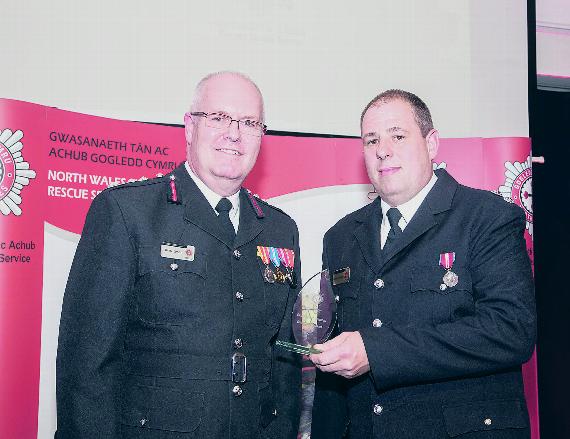 Simon Smith presenting Richard Hodges, the watch manager at Harlech, with the Station of the Year award