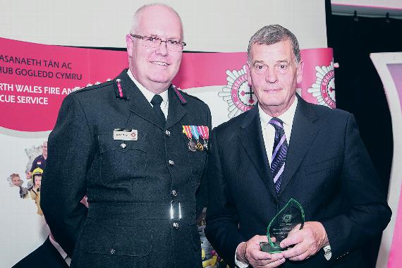 Chief fire officer Simon Smith presenting the owner of Land and Sea, Trevor Bethell, with the Employer of the Year award