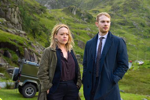 Pictured with the background of the Snowdonia mountains are DI Cadi John (Sian Reese-Williams) and DS Owen Vaughan (Sion Alun Davies)