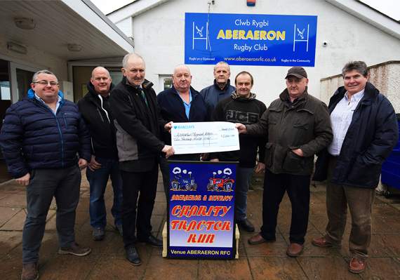 Aberaeron and District Charity Tractor Run organisers presenting a £2,000 cheque to John Lewis, chairman of Aberaeron Town Improvements