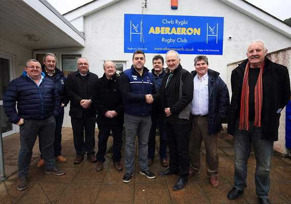 Ywain ap Dylan, chairman of Aberaeron RFC, presenting a cheque of £1,500 to John Lewis
