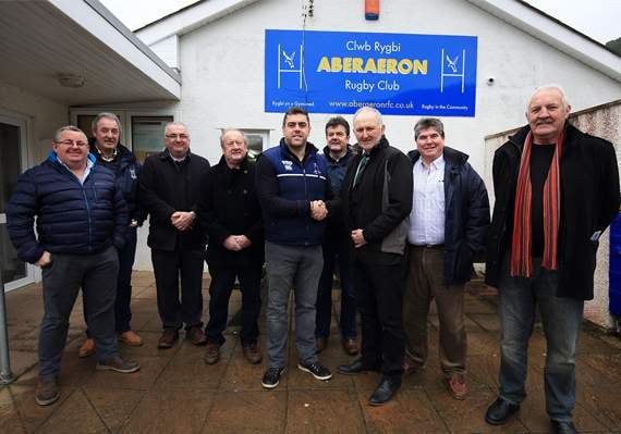 Ywain ap Dylan, chairman of Aberaeron RFC, presenting a cheque of £1,500 to John Lewis