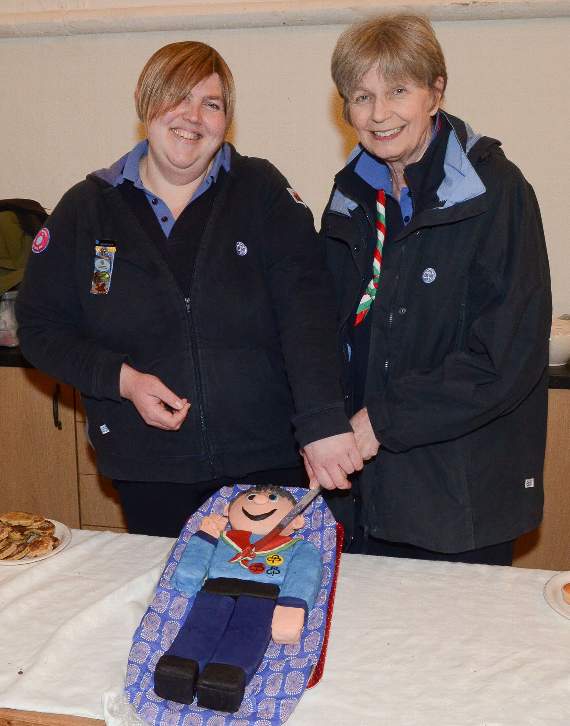 Pictured cutting the special cake are Nikki Mead, Lampeter leader, who made the cake, and retiring district commissioner Anthea Lister