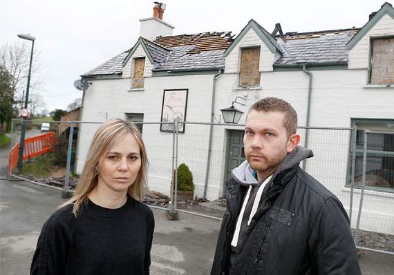 Caitlin Morse and Lewis Johnston outside the fire-ravaged pub