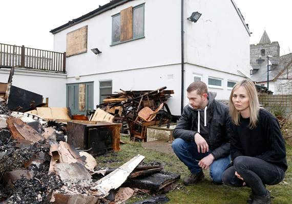 Caitlin and Lewis survey the damage to their pub on Tuesday morning