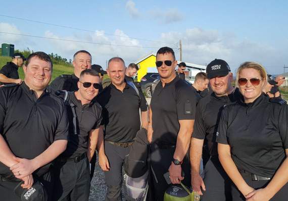 PC Matt Richards (left) with fellow British police officers on arrival at Paragon Camp, Barbados, en route to their deployment to the British Virgin Islands
