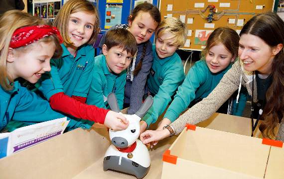 Ysgol Llannon pupils Honey Forbes-Chapman, Natasha Wyley, Dominik Sikova-Wright, Layla Forbes-Chapman, Coby Jones and Seren Evans with Patricia Shaw, computer science lecturer, at the Clwb Robotics Aberystwyth stand