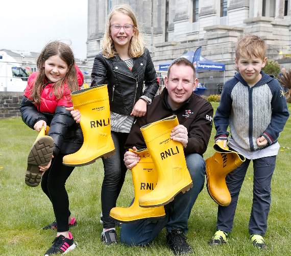Catrin Daniel, Lleucu Nest, Aberystwyth RNLI crew member Paul McCann and Pwyll Siencyn have a go at welly-throwing
