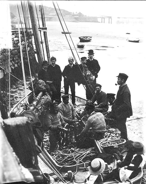 A fishing boat unloading its catch in Barmouth. The photograph is believed to have been taken around 1900