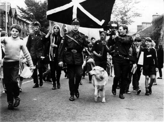 Dennis Coslett and Gelert the dog leading the Free Wales Army procession in Machynlleth