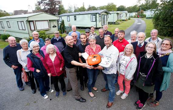 Phillip Garrod and Gareth Nicholas of Welsh Hearts; Neil, Julia and Christian Warren-Kyle and Ivan Warren; with villagers and caravan owners who attended the evening of defibrillator training