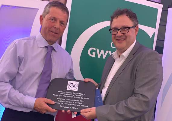 Owain Williams from the Gwynedd Business Network presenting an award to Geraint Jones, Becws Islyn, Aberdaron, as the Gwynedd Business Person of the Year