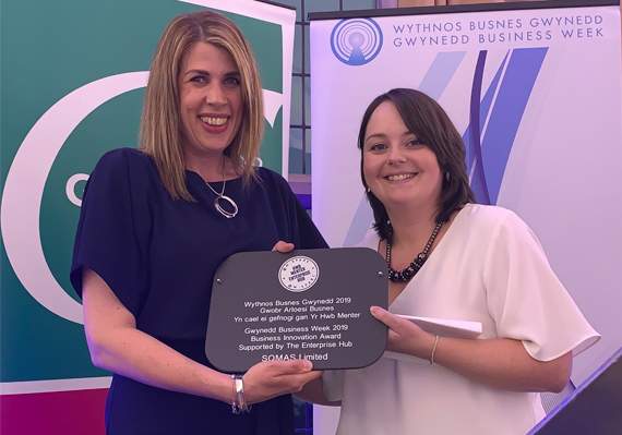 Toni Bailey (SQMAS Ltd) receiving the Business Innovation Award from Zoe Pritchard, Menter Môn