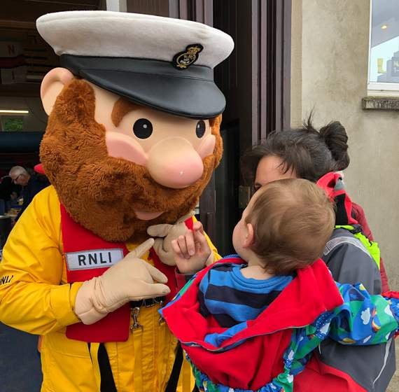 RNLI mascot Stormy Stan greets a potential future lifeboat crew member