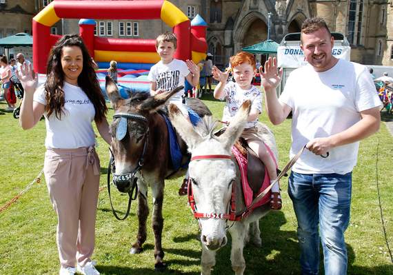 Iori Jenkins, of Aberystwyth and Archie Morrison, of Talybont enjoy a donkey ride, led by Emma Vaughan-Butters and Alun Jones