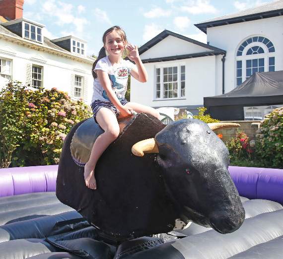 Lili Stubbs, of Llanon, has a go on a mechanical bull