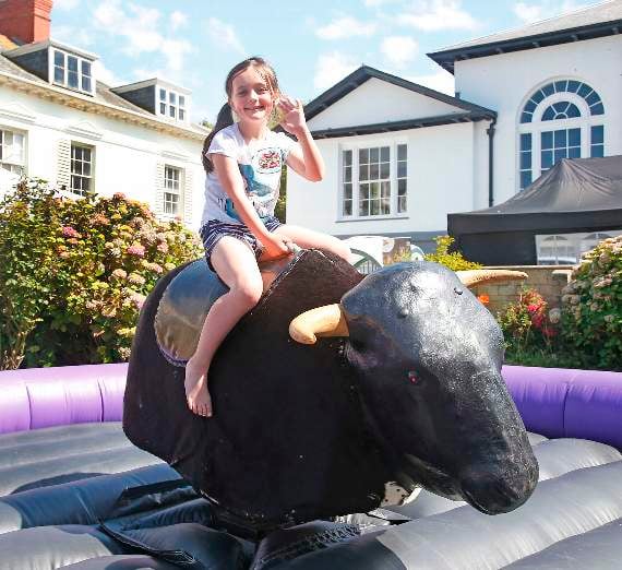 Lili Stubbs, of Llanon, has a go on a mechanical bull