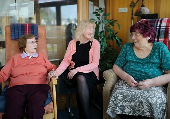 Dilys (centre) enjoying a joke with Betty and Valmai, residents at Hafan Deg