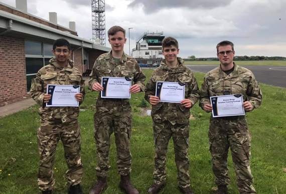 Cdt Siddhant Bohra, Cpl William Davies, Sgt Owain Wilson and CWO Llyr Evans with their new wings and certificates